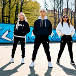 **

"A bustling K-Pop dance practice in a Stockholm park. Young Swedes, diverse and energetic, are fully clothed in stylish streetwear, mimicking a complex K-Pop choreography. Graffiti art adorns the backdrop, blending Scandinavian minimalist aesthetics with vibrant K-Pop visuals. Soft, diffused sunlight, safe for work, appropriate content, professional, modest, perfect anatomy, natural proportions, well-formed hands."

**